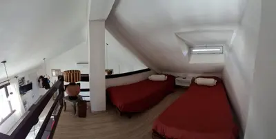 a living room with a red couch and a window at Casa con piscina vista al lago montañas-Sierras de Córdoba in Villa Parque Siquiman