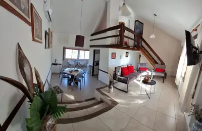 an overhead view of a living room with a spiral staircase at Casa con piscina vista al lago montañas-Sierras de Córdoba in Villa Parque Siquiman