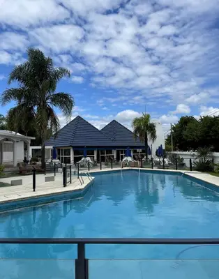 a large swimming pool in front of a house at Hotel Rossetti y Spa in Mina Clavero