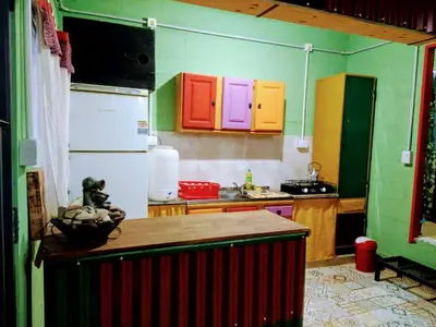 a kitchen with brightly colored cabinets and a refrigerator at El Escarabajo Azul loft & Arte in Villa Carlos Paz