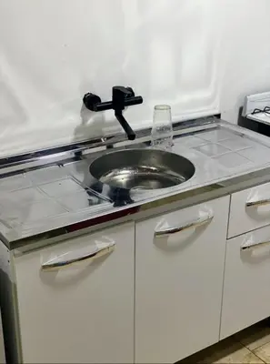 a kitchen counter with a sink in a counter top at Cabañas La Esperanza in Quebrada de los Pozos