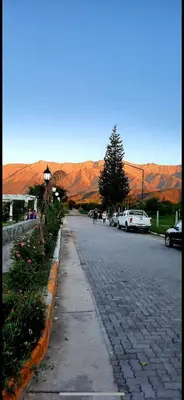 a cobblestone street with mountains in the background at Cabañas La Esperanza in Quebrada de los Pozos