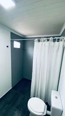 a bathroom with a toilet and a shower curtain at Cabañas La Esperanza in Quebrada de los Pozos