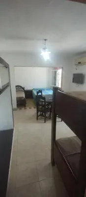 a living room with a table and a dining room at Hospedaje Don Juan in Villa Dolores