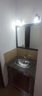 a bathroom with a sink and a mirror at Hospedaje Don Juan in Villa Dolores