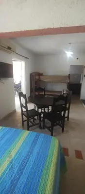 a room with a table and chairs in a room at Hospedaje Don Juan in Villa Dolores
