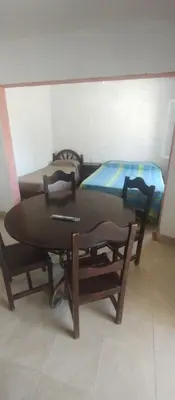 a table and chairs in a room with a bed at Hospedaje Don Juan in Villa Dolores