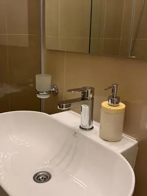 a white bathroom sink with a soap dispenser on it at Apartamento en Colón y Cañada in Cordoba
