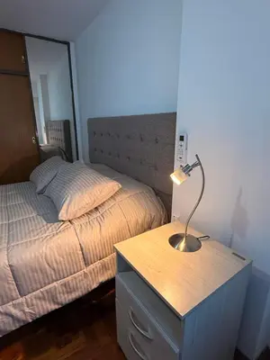 a bedroom with a bed and a desk with a lamp at Apartamento en Colón y Cañada in Cordoba
