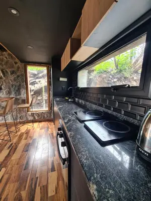 a kitchen with a stove and a counter top at Chalet - Stone Cabin in Villa Icho Cruz