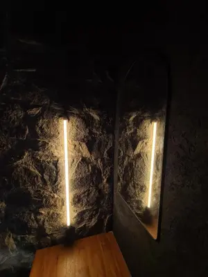two lights in a dark room with a wooden table at Chalet - Stone Cabin in Villa Icho Cruz