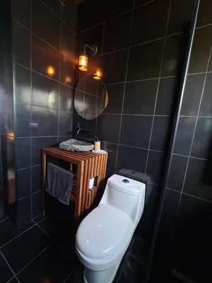 a bathroom with a toilet and a mirror at Chalet - Stone Cabin in Villa Icho Cruz