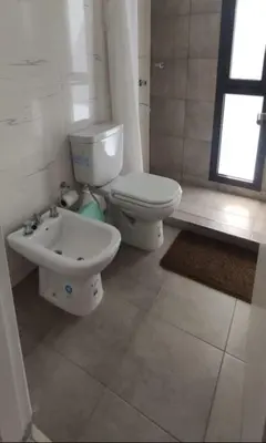 a bathroom with a toilet and a sink at Accarezza in Villa Carlos Paz