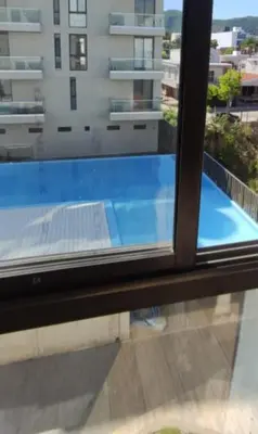 a view of a swimming pool from a window at Accarezza in Villa Carlos Paz