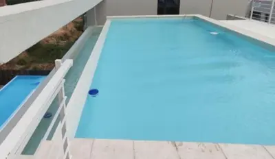 a large swimming pool with a blue pool at Accarezza in Villa Carlos Paz