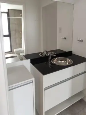 a white bathroom with a sink and a toilet at Accarezza in Villa Carlos Paz