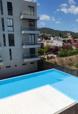 a swimming pool on the side of a building at Accarezza in Villa Carlos Paz
