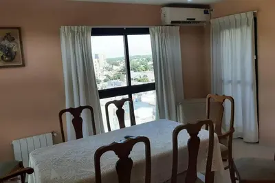 a bedroom with a bed and a large window at Céntrico y totalmente equipado depto en Río Cuarto in Río Cuarto