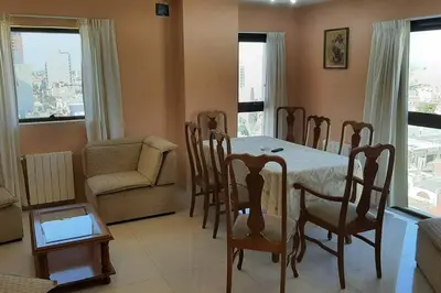 a dining room with a table and chairs and a couch at Céntrico y totalmente equipado depto en Río Cuarto in Río Cuarto