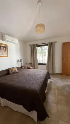 a bedroom with a large bed and a window at CABAÑA PREMIUM in Villa Carlos Paz