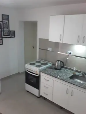 a kitchen with a stove and a sink in it at El Dpto de Gabicito in Cordoba