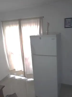 a white refrigerator in a room with a window at El Dpto de Gabicito in Cordoba