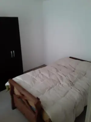 a bed in a room with a white mattress at El Dpto de Gabicito in Cordoba