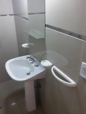 a bathroom with a white sink and a mirror at El Dpto de Gabicito in Cordoba