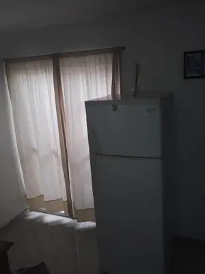 a white refrigerator in a room with a window at El Dpto de Gabicito in Cordoba