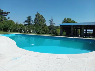 a large blue swimming pool with a gazebo at Villa francisca amarilla in La Bolsa