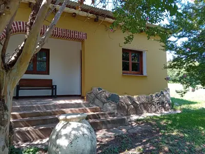 a yellow house with a vase in front of it at Villa francisca amarilla in La Bolsa