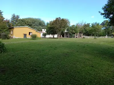 a large yard with a house in the background at Villa francisca amarilla in La Bolsa