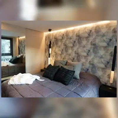 a bedroom with a bed with a stone wall at Ópera Park royal life in Cordoba