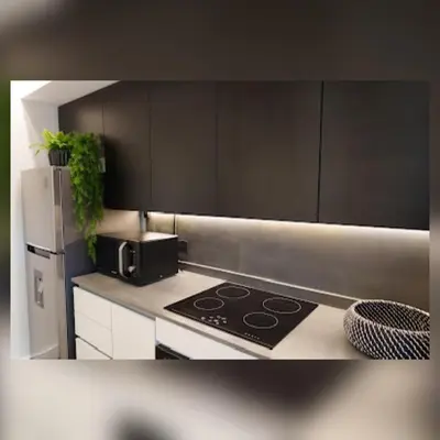 a kitchen with a stove and a refrigerator at Ópera Park royal life in Cordoba