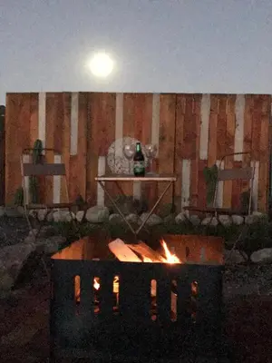 a fire pit with a table and a chair at Agave Serrano in Villa Rumipal