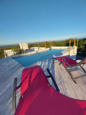 a pair of chairs sitting on top of a swimming pool at Agave Serrano in Villa Rumipal