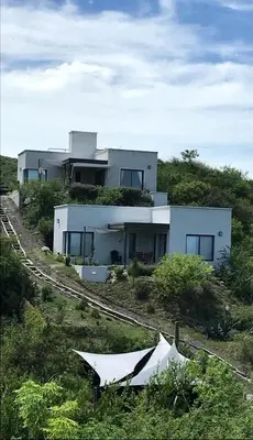 a house sitting on top of a hill at Agave Serrano in Villa Rumipal