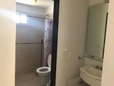a bathroom with a toilet and a sink at Carlos Paz, Villa Santa Cruz del Lago in Villa Carlos Paz