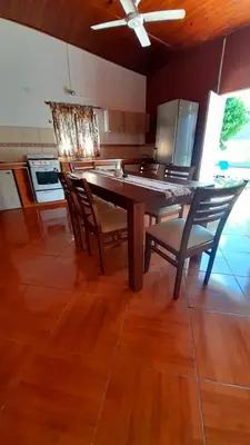 a kitchen with a dining room table and chairs at Los Velitos in Santa Rosa del Conlara