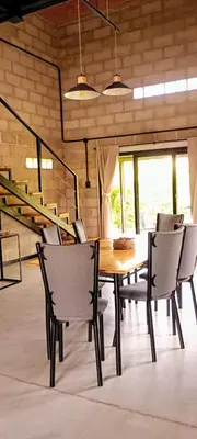 a dining room with a wooden table and chairs at ALMA Posada in Almafuerte