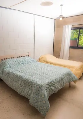a bedroom with two beds and a window at ALMA Posada in Almafuerte