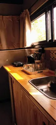 a kitchen with a sink and a wooden counter top at ALMA Posada in Almafuerte