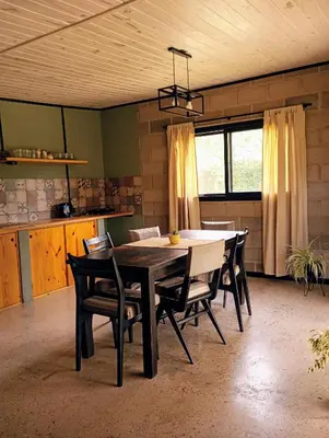 a dining room table and chairs in a room at ALMA Posada in Almafuerte