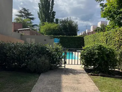a gate to a house with a swimming pool at Departamento Familiar!! Excelente entorno!! (#35) in Villa Carlos Paz