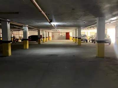an empty parking lot with cars parked in a parking garage at Departamento Familiar!! Excelente entorno!! (#35) in Villa Carlos Paz
