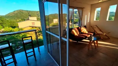 a living room with a couch on a balcony at La casita de balcones in Villa Independencia