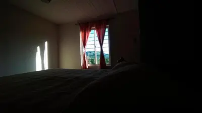 a bedroom with a bed and a window at La casita de balcones in Villa Independencia