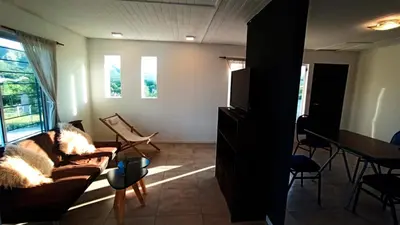 a living room with a couch and a flat screen tv at La casita de balcones in Villa Independencia