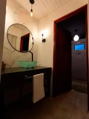 a bathroom with a sink and a mirror at La casita de balcones in Villa Independencia