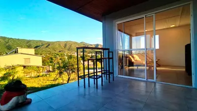 a balcony with two chairs and a view of the mountains at La casita de balcones in Villa Independencia
